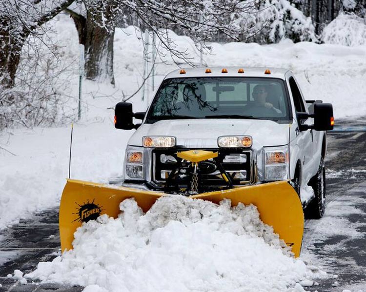 pickup truck plowing snow with a fisher plow